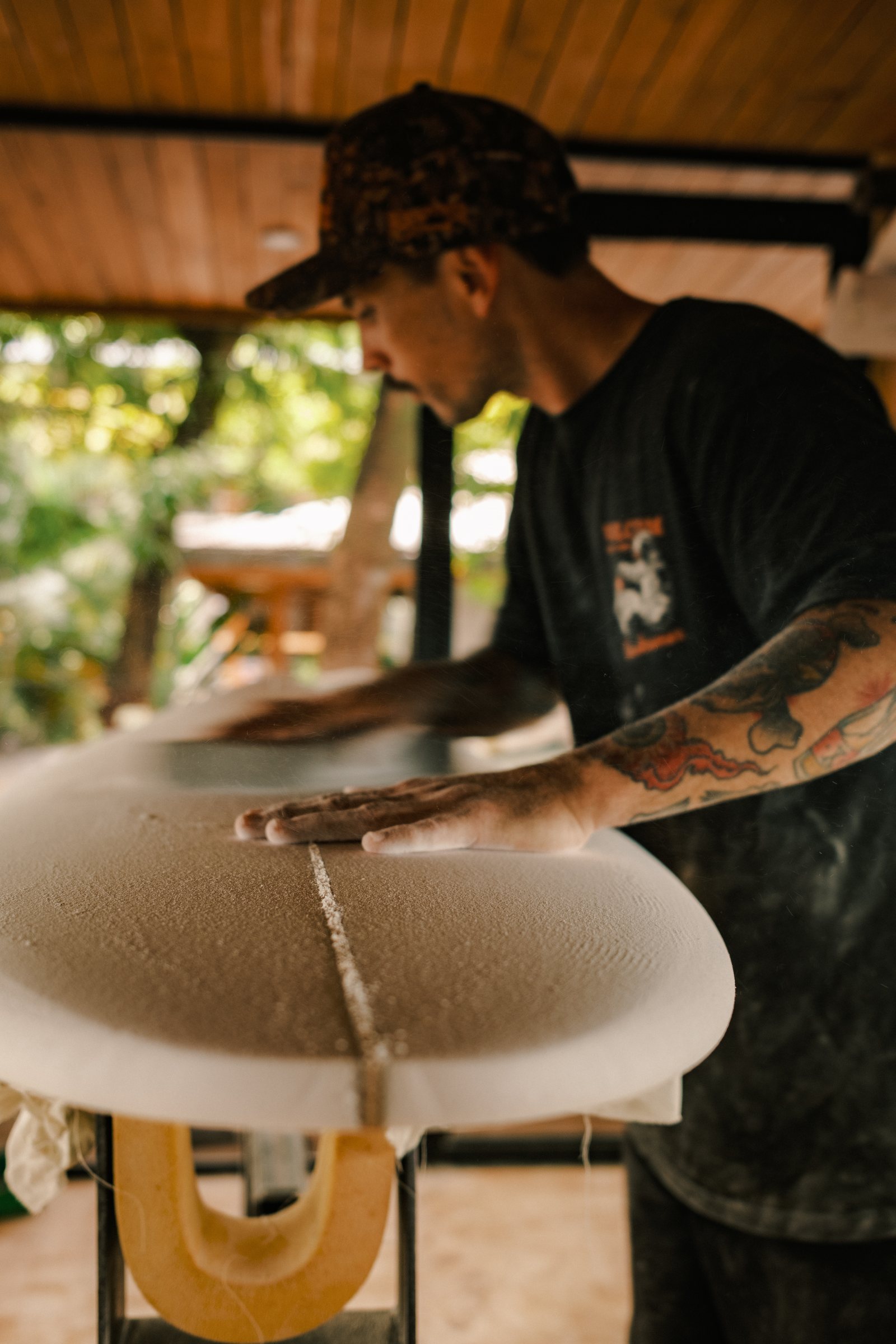 Mark Cormack shaping a surfboard blank in the open-air shaping bay