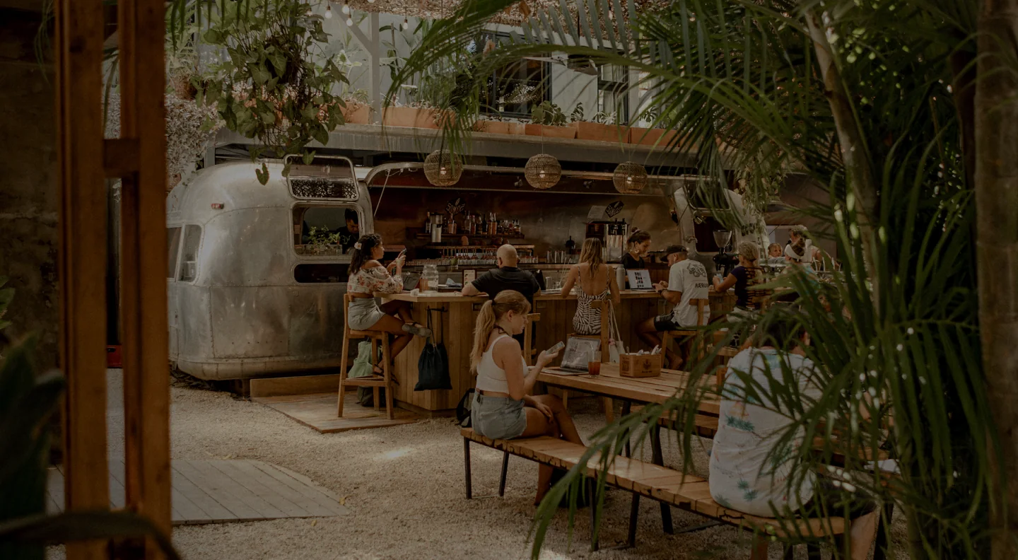 Guests dining beside the Airstream restaurant at House of Somos