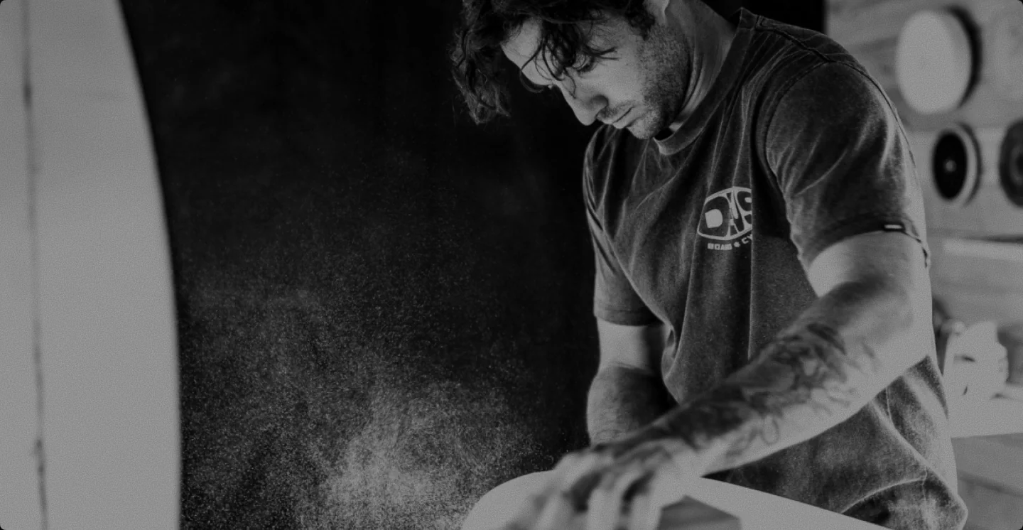 Surfboard shaper working in the workshop