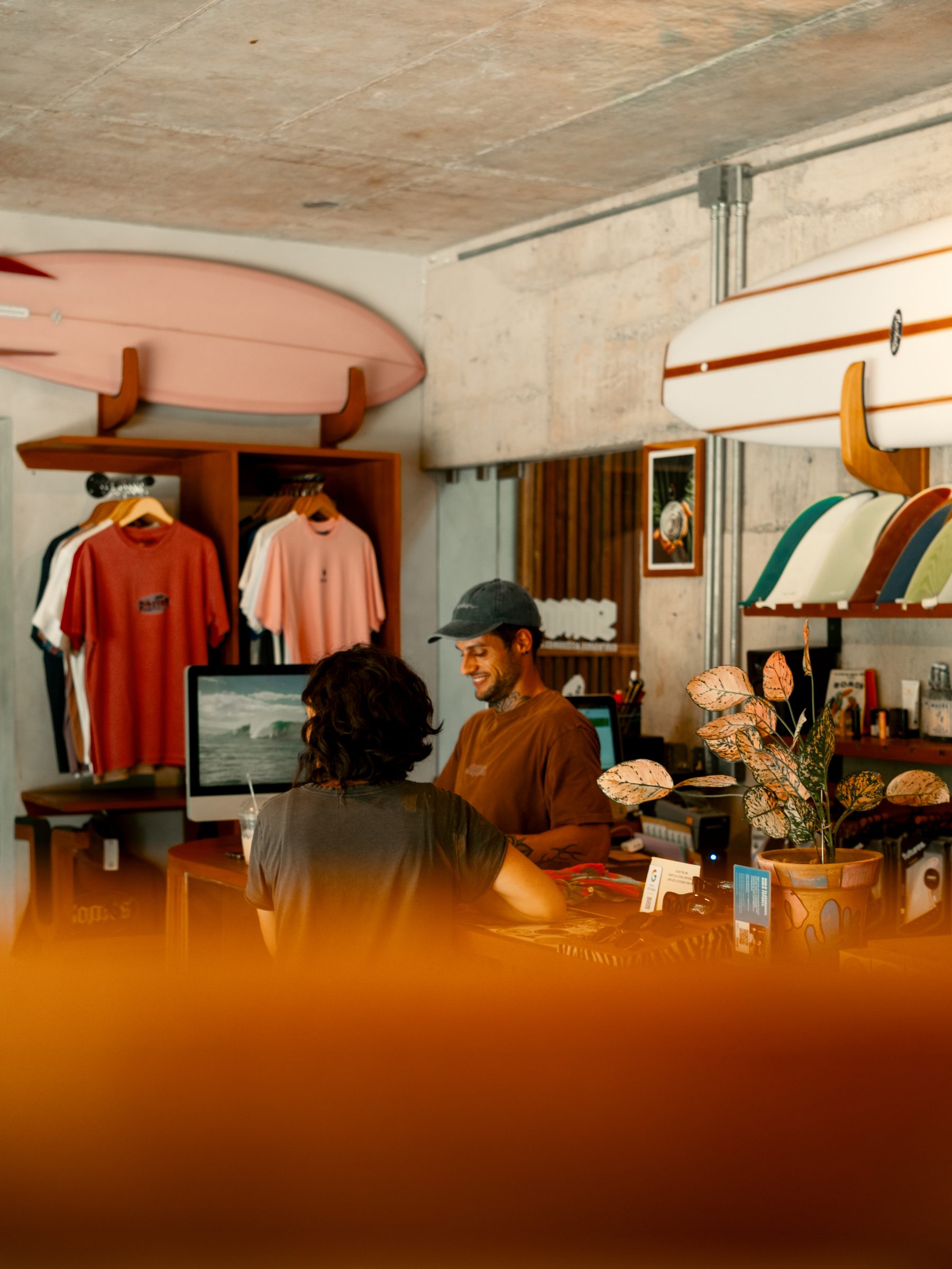 Customer chatting with staff at the Somos shop counter