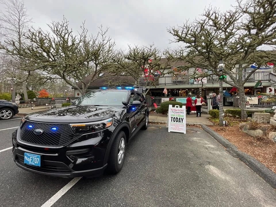 A Brewster Police cruiser parked outside a village shop during a Stuff-a-Cruiser community event