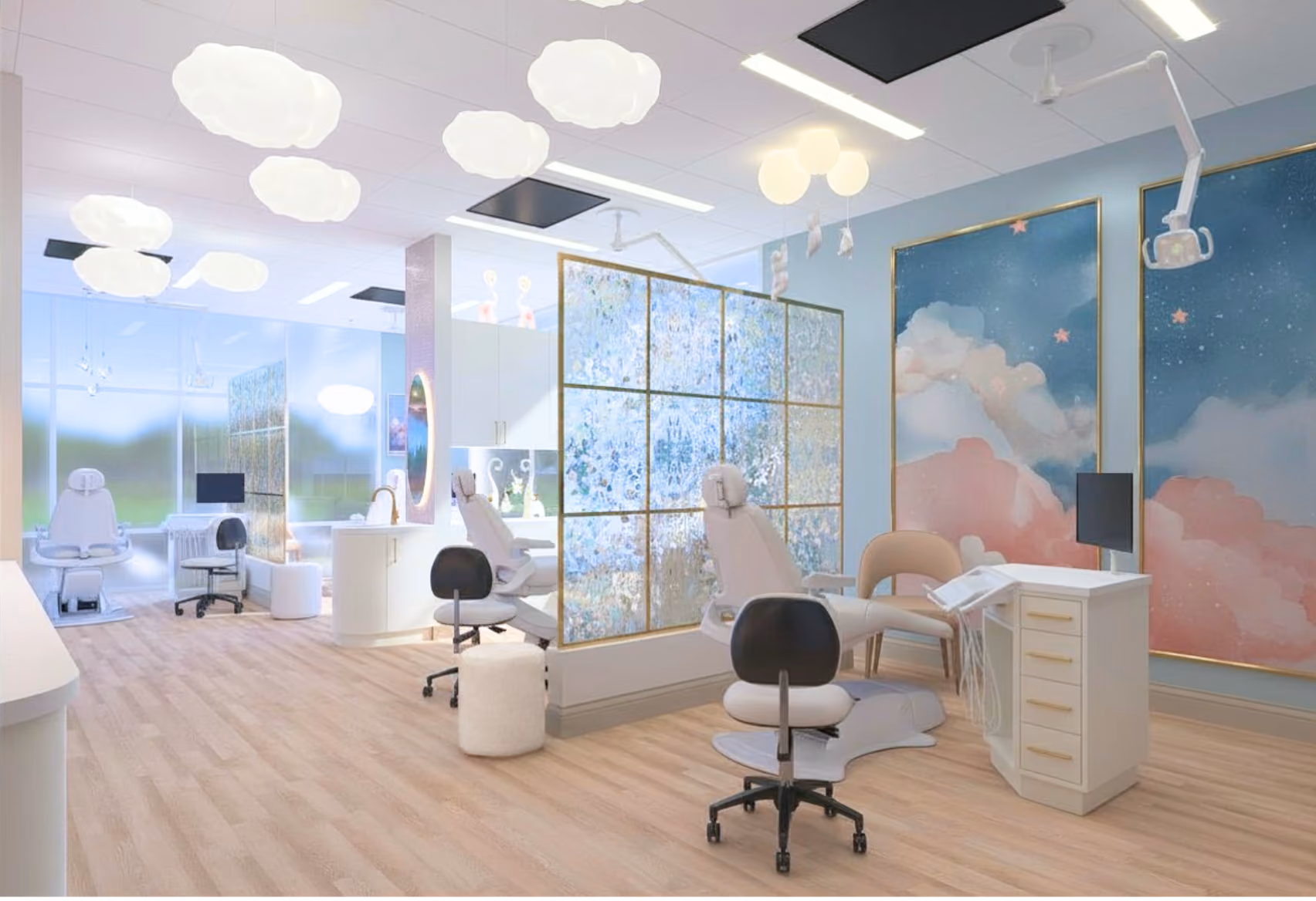 Bright and modern dental clinic room with multiple dental chairs separated by decorative translucent partitions, light wood flooring, cloud-shaped ceiling lights, comfy chairs, and whimsical wall art featuring clouds and stars.