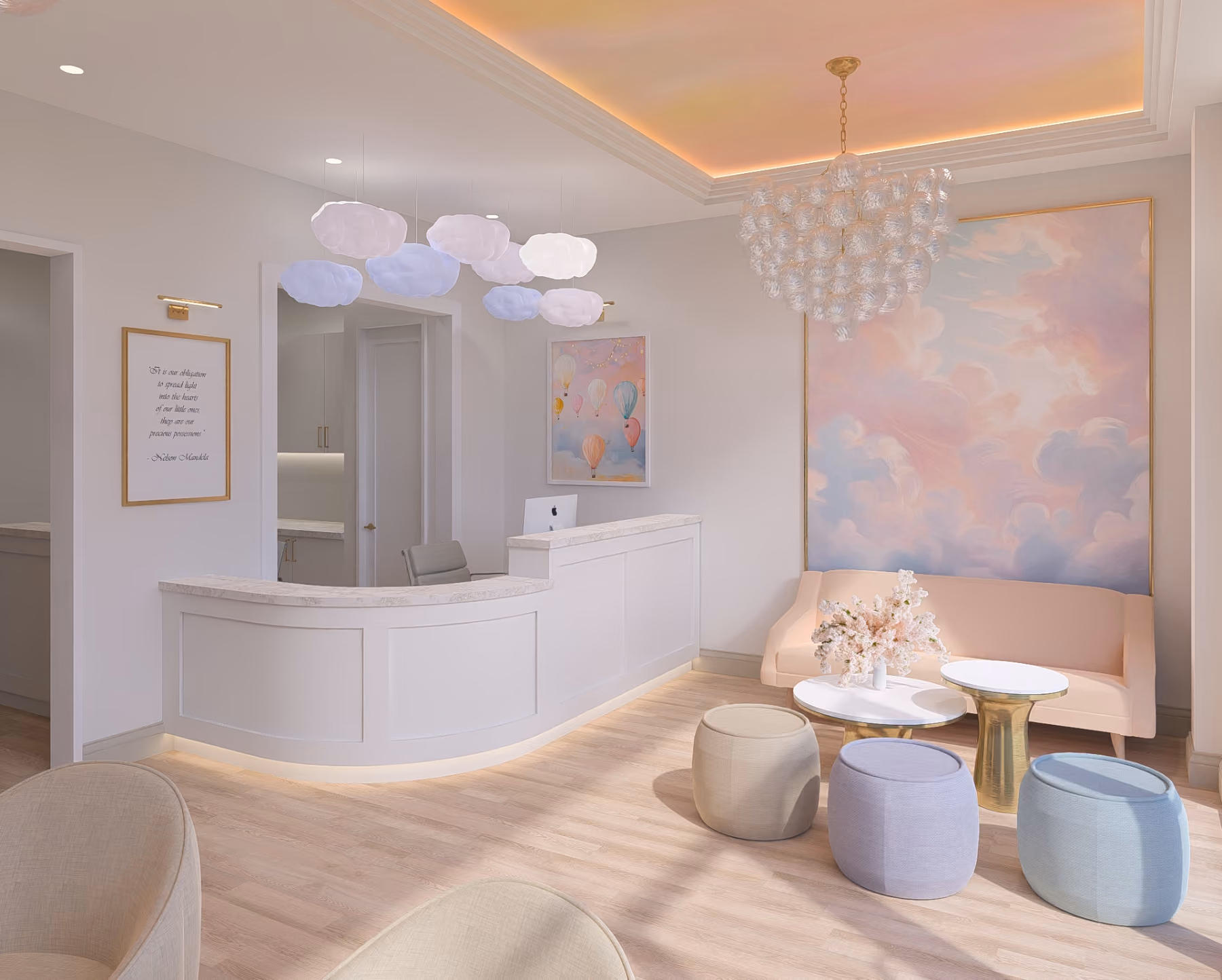 Reception lobby with a curved white desk featuring a computer and gray chair, illuminated cloud-shaped pendant lights above, a pastel pink sofa, three round ottomans in beige, lavender, and light blue, two small white and gold tables with a flower arrangement, soft wooden flooring, and wall art including a balloon painting and a large pastel cloud mural with a modern chandelier.