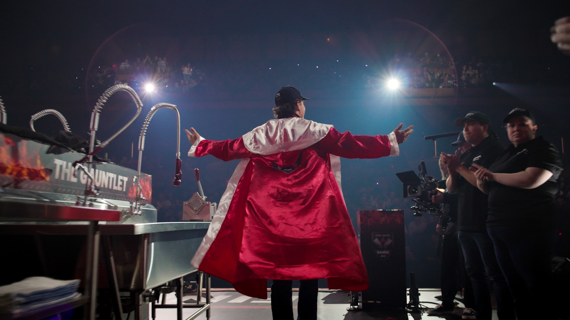 On The Line — competitor in a red robe entering the World Burger Games