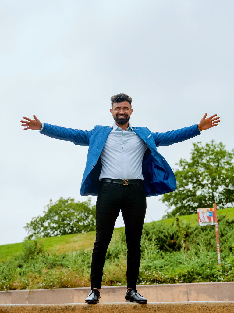 Steev Yosupov outdoors in Denver with his arms open