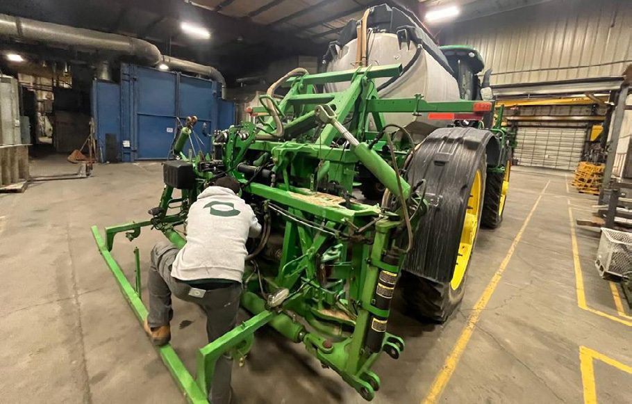 Scott Arthaud’s John Deere sprayer being retrofitted with the Greeneye system in a workshop
