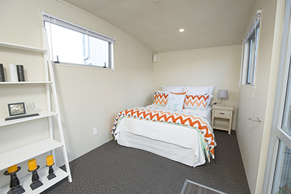 The kitchen, dining and bedroom in the Kestrel Studio Rental Cabin