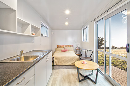 The kitchen, dining and bedroom in the Kestrel Studio Rental Cabin