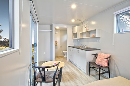 Kitchen through to the ensuite of the Kestrel Studio Rental Cabin