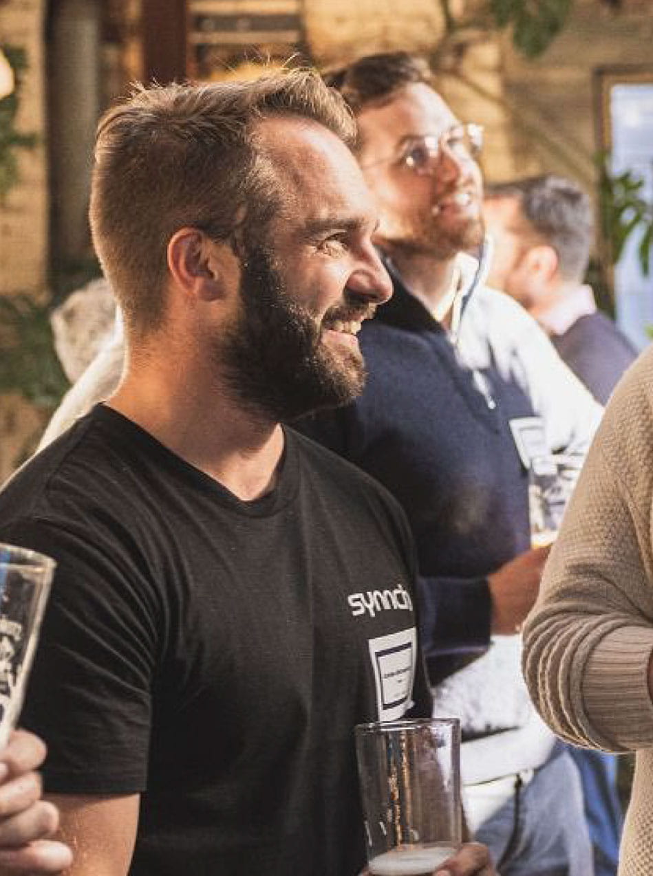 Andrew talking to a guest at a Synnch event in Melbourne brewhouse