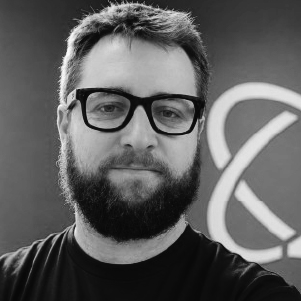 Man with a beard and glasses looking at camera