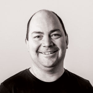 A smiling man with a black shirt