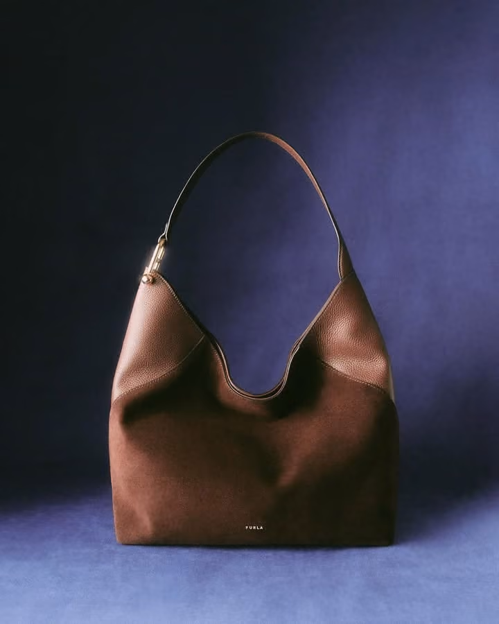 Tan leather shoulder bag with a blue lining