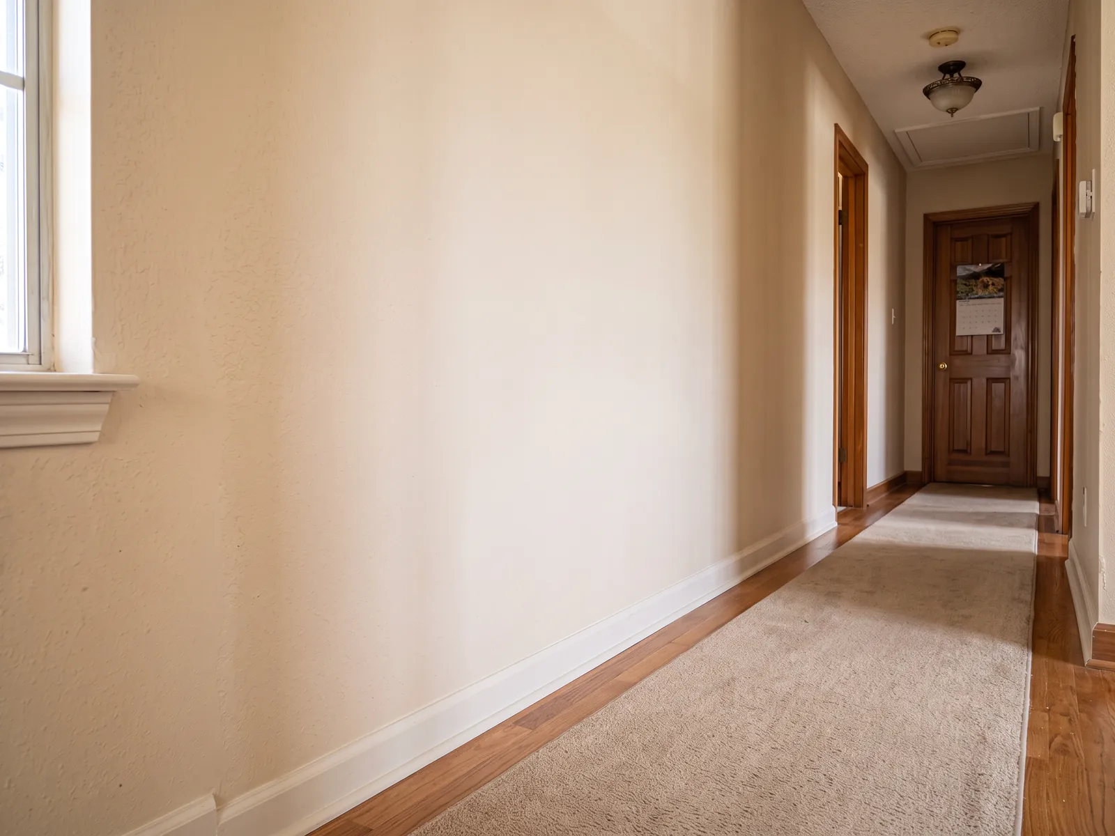 The same hallway repaired and repainted after the one-day repipe