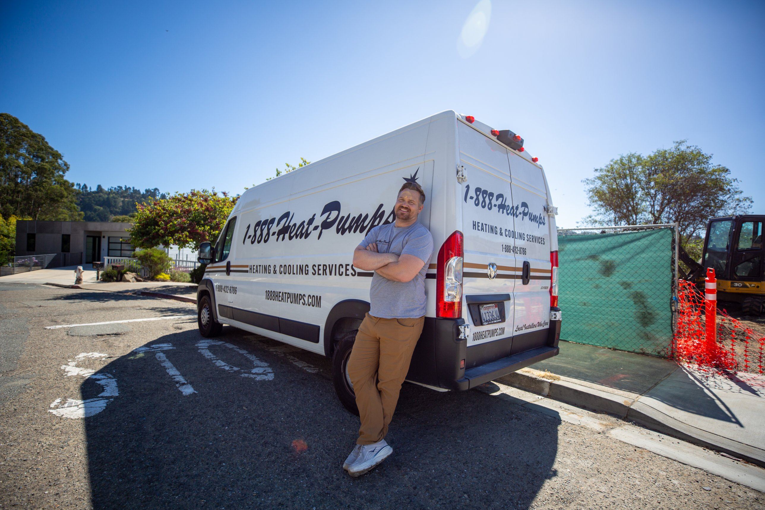 Owen leaning on the 1-888-Heat-Pumps van
