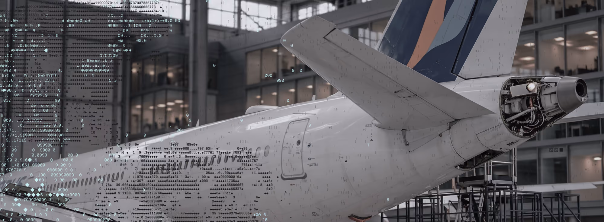Close-up of the rear section of a white commercial airplane in a spacious hangar, showing the tail fin, wing, and exposed engine components under maintenance.