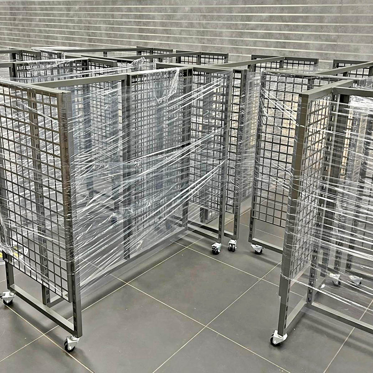 Retail display fixtures being installed during a sports store fit-out.