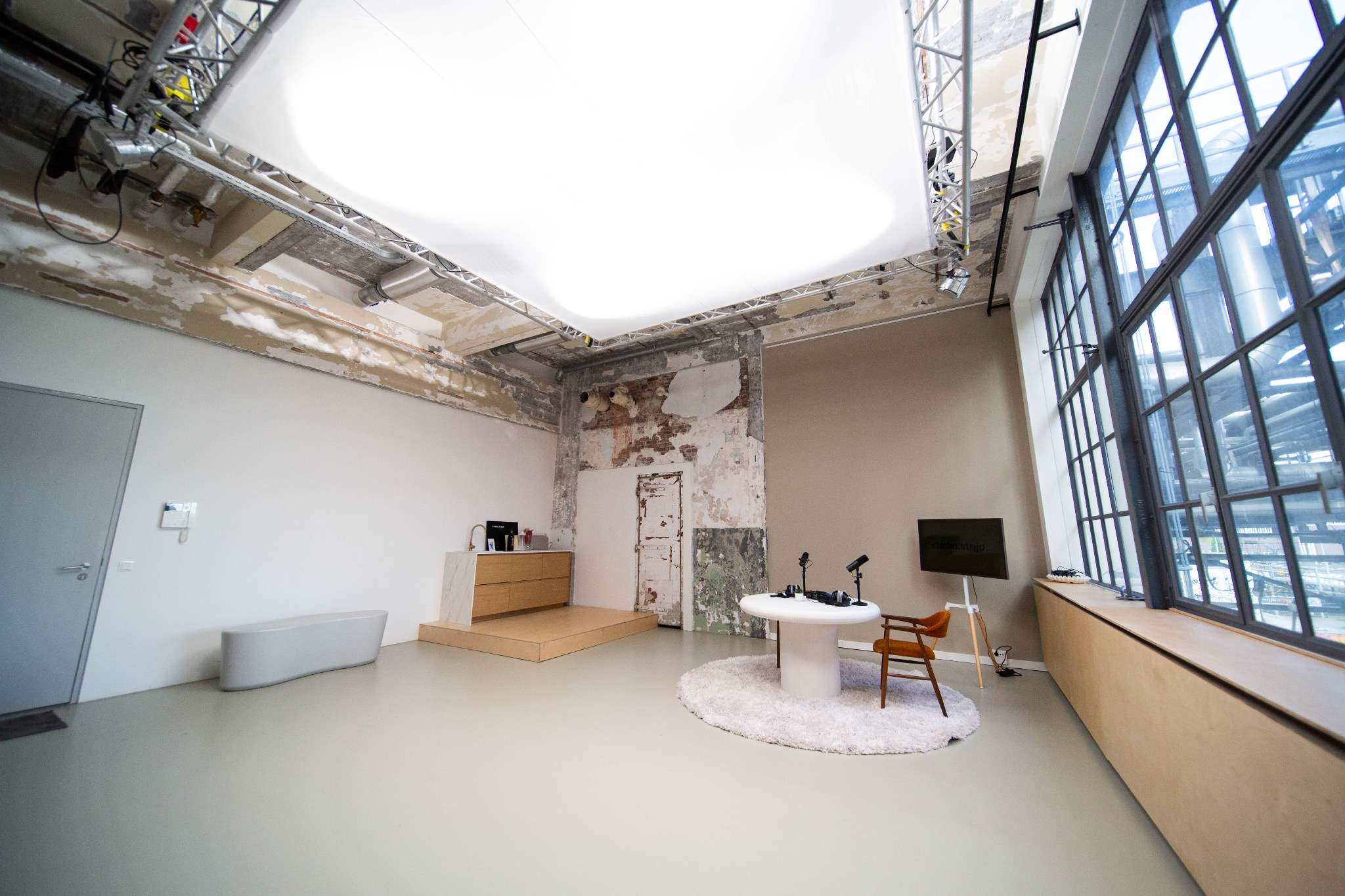 Studio.Strijp — overzicht van de studio met ramen en zithoek