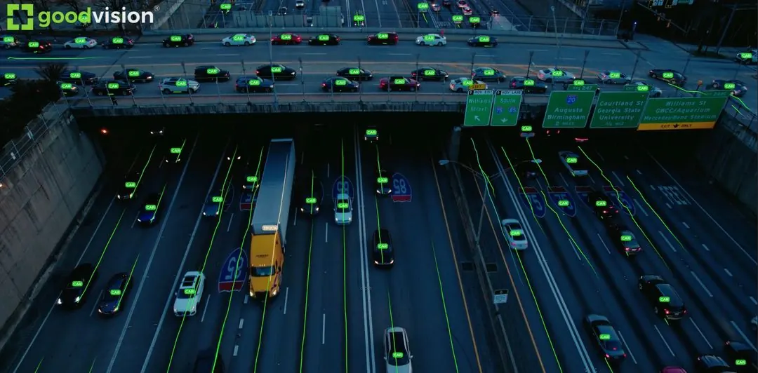 Aerial view of a multi-lane highway at dusk with GoodVision detections on each vehicle