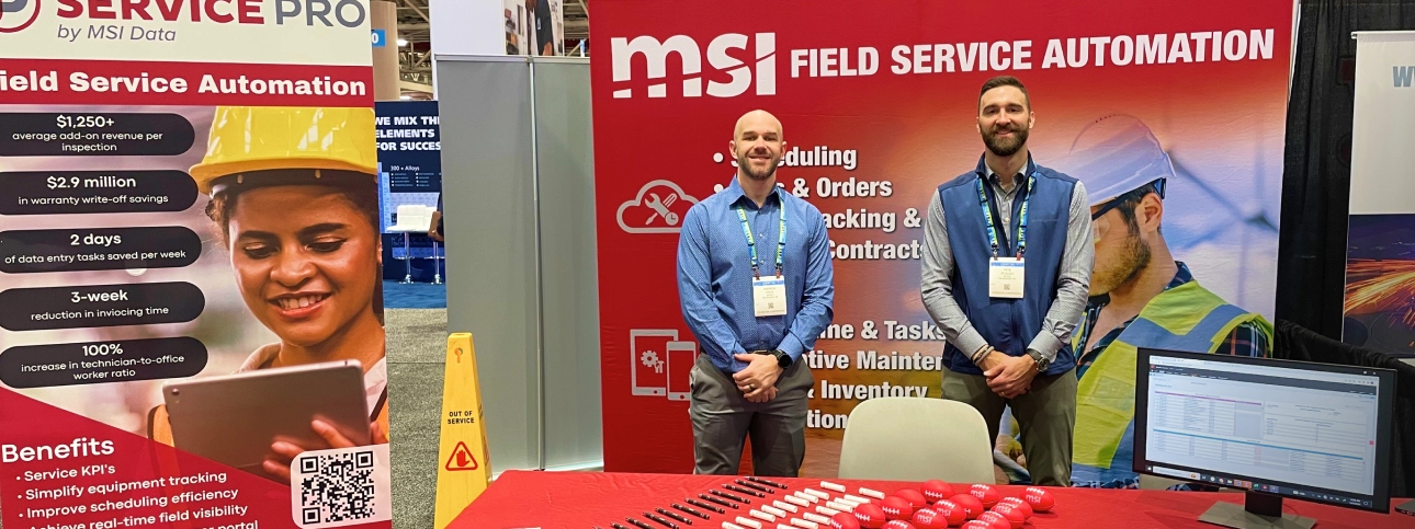 Photo of two MSI Data employees at their trade show booth.