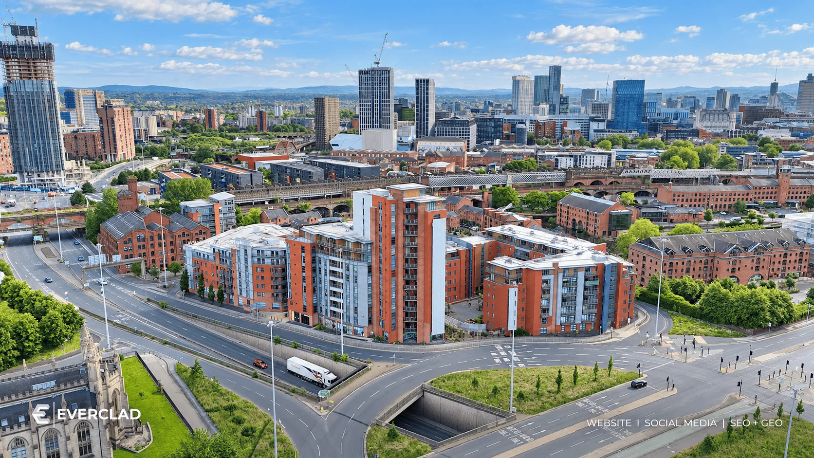Aerial view of Everclad-clad apartment blocks in a UK city, website, social media and SEO + GEO by Just Chill