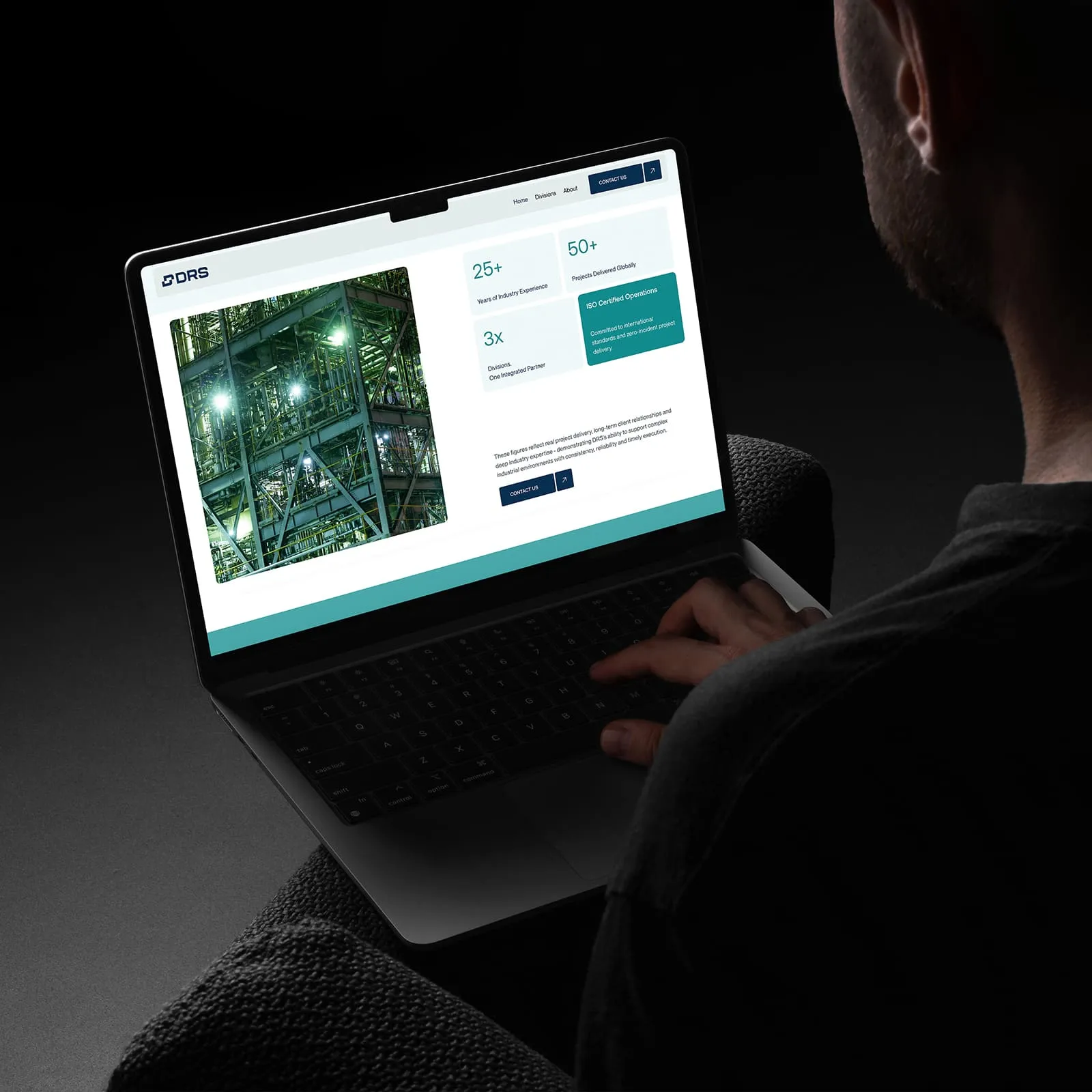 Person using a laptop showing the DRS Engineering website