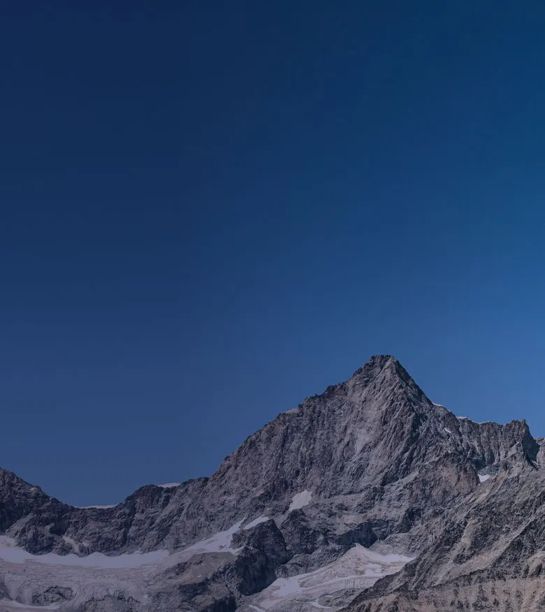 Snowy mountain range under a blue sky