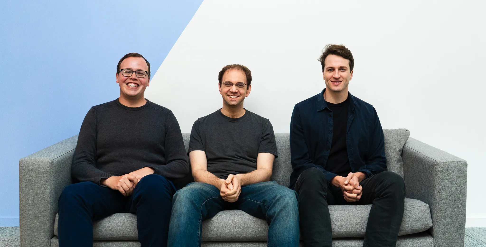 Arch founders seated on a sofa