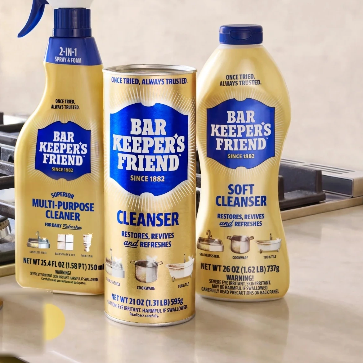 Bar Keeper's Friend spray, cleanser, and soft cleanser bottles in a kitchen