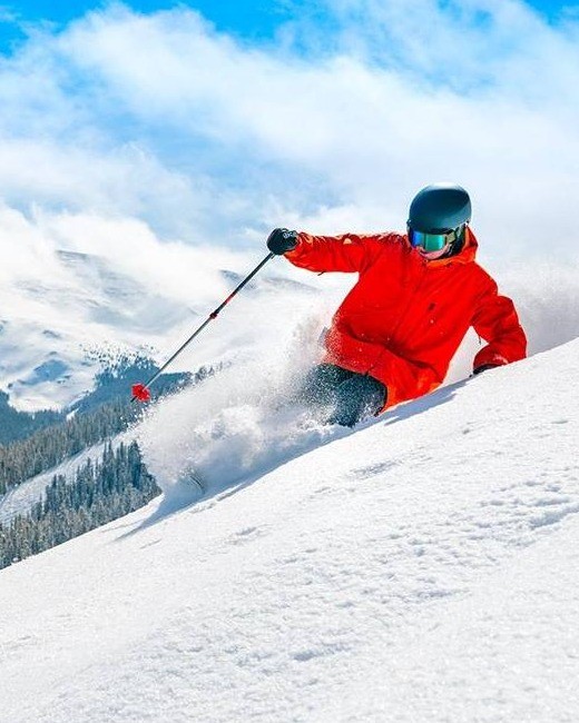 Skier carving through fresh powder at Winter Park Resort