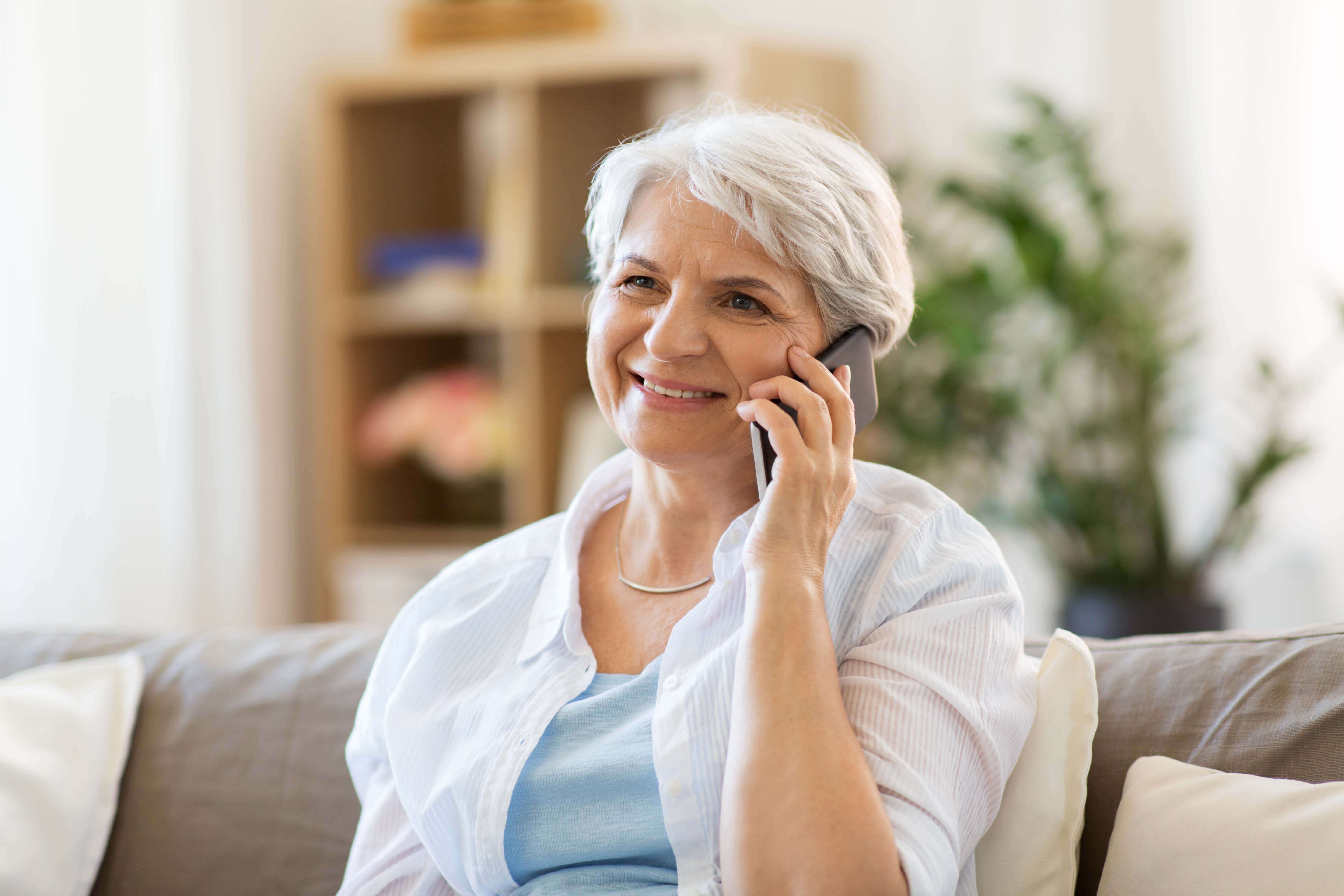 Senior woman talking on the phone at home