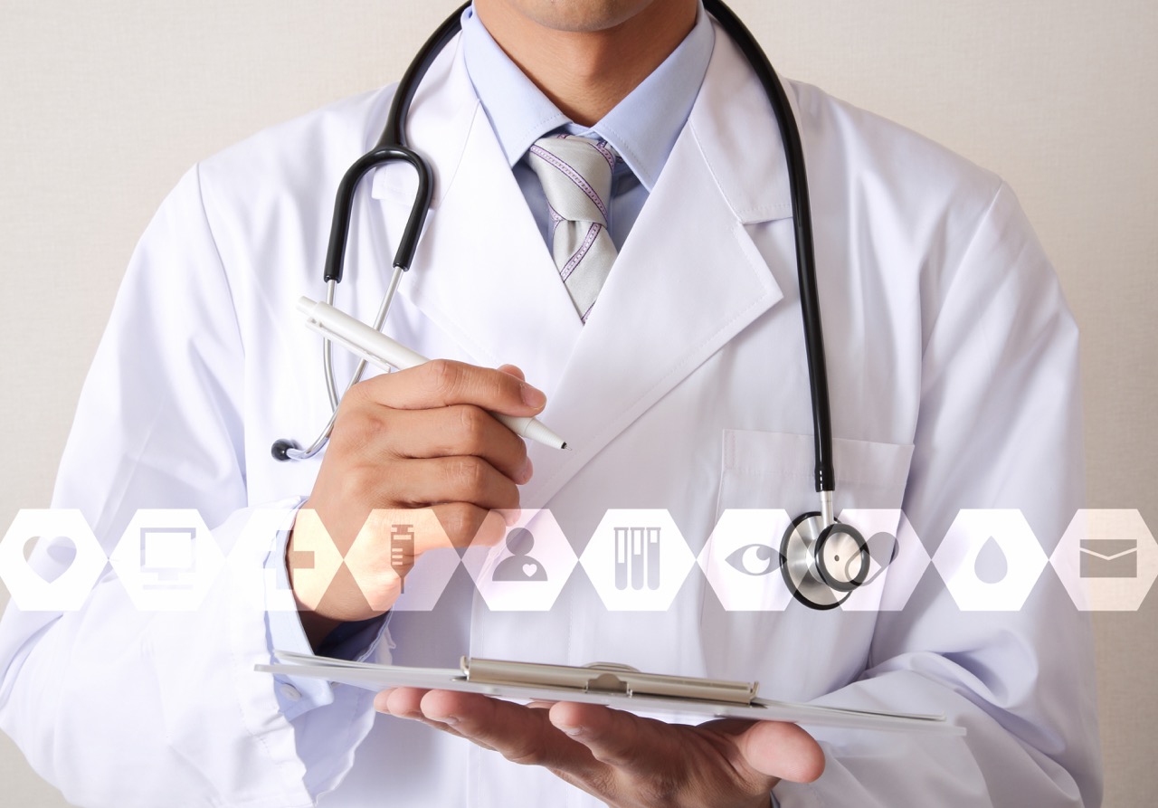 Physician holding a clipboard with digital health icons