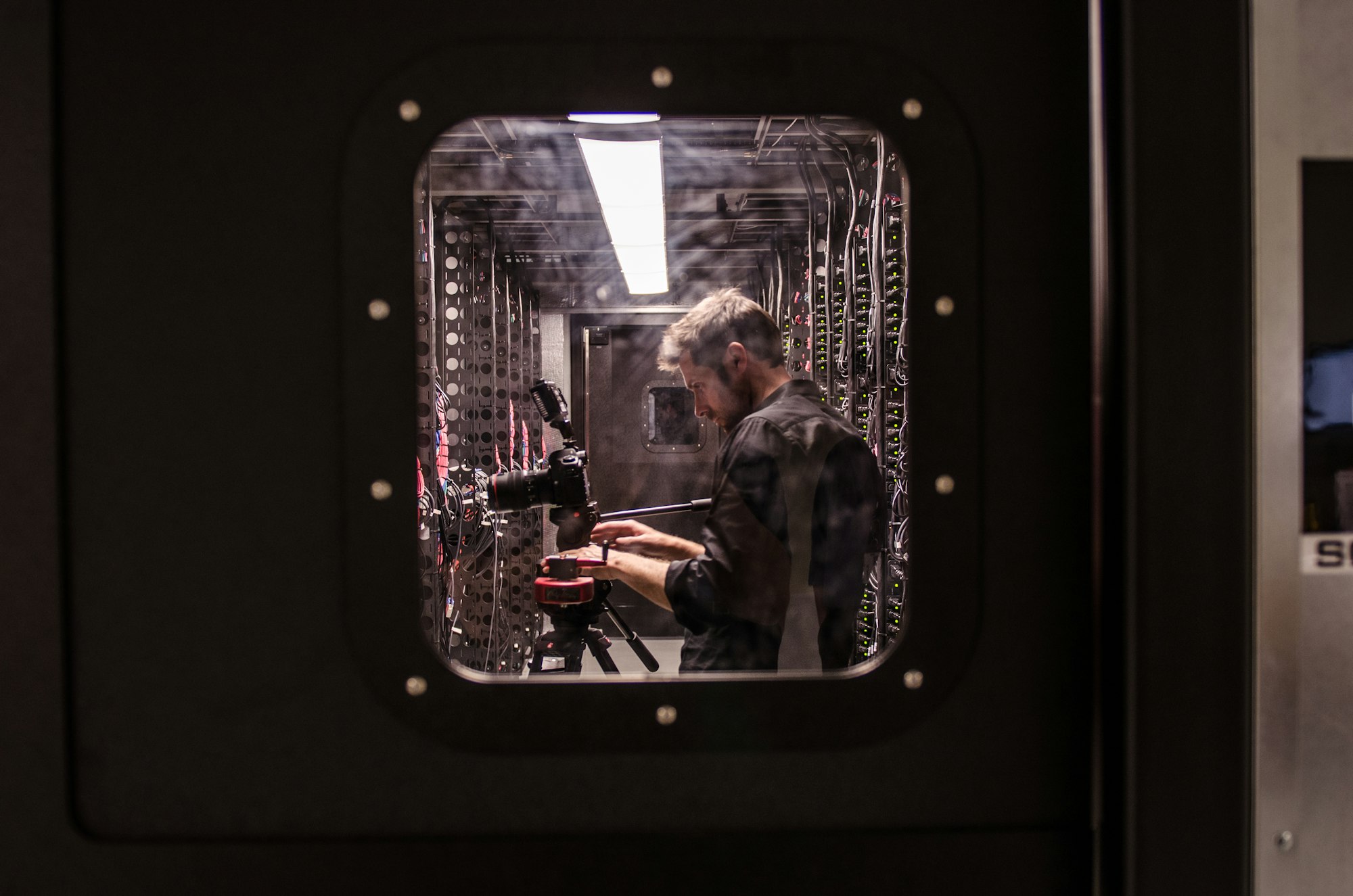Technician working inside a secured data center cage