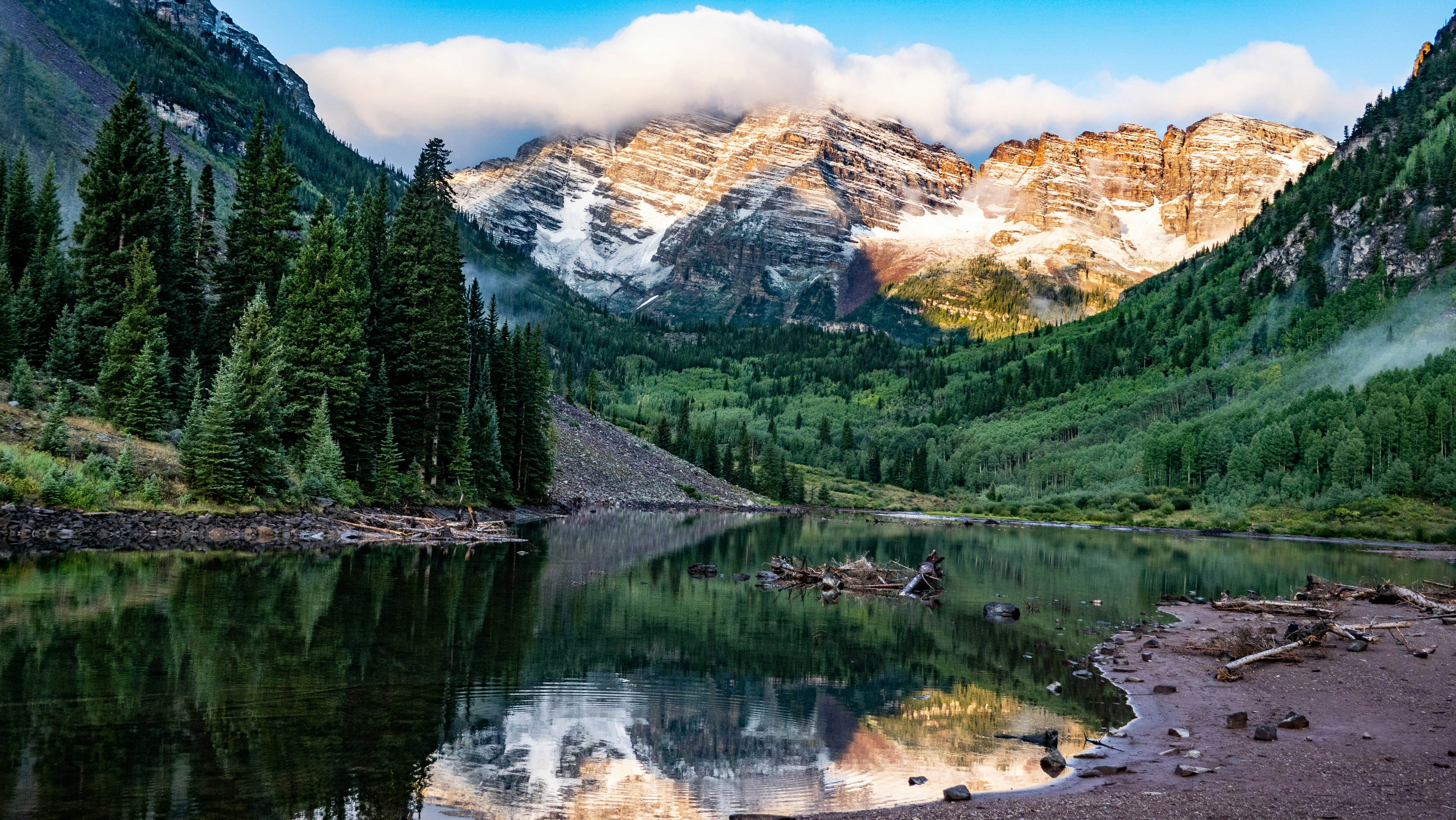 A quiet alpine lake beneath Colorado mountain peaks