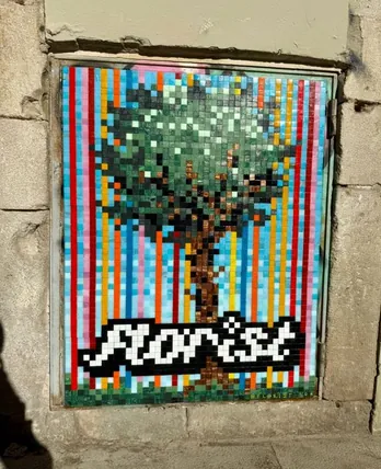 Glass mosaic of a pixel-style tree over rainbow stripes with the word “florist”, set into a stone wall — by @florist.ldn