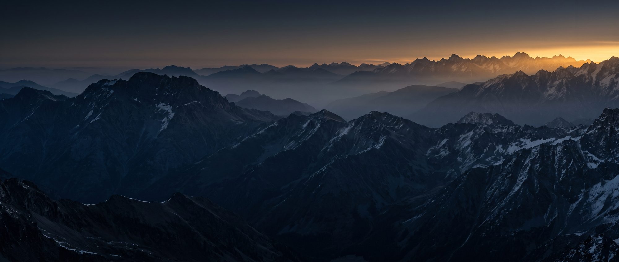 First light breaking across a mountain range at dawn