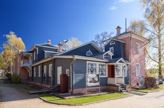 Two-storey timber home with a brick tower and front garden