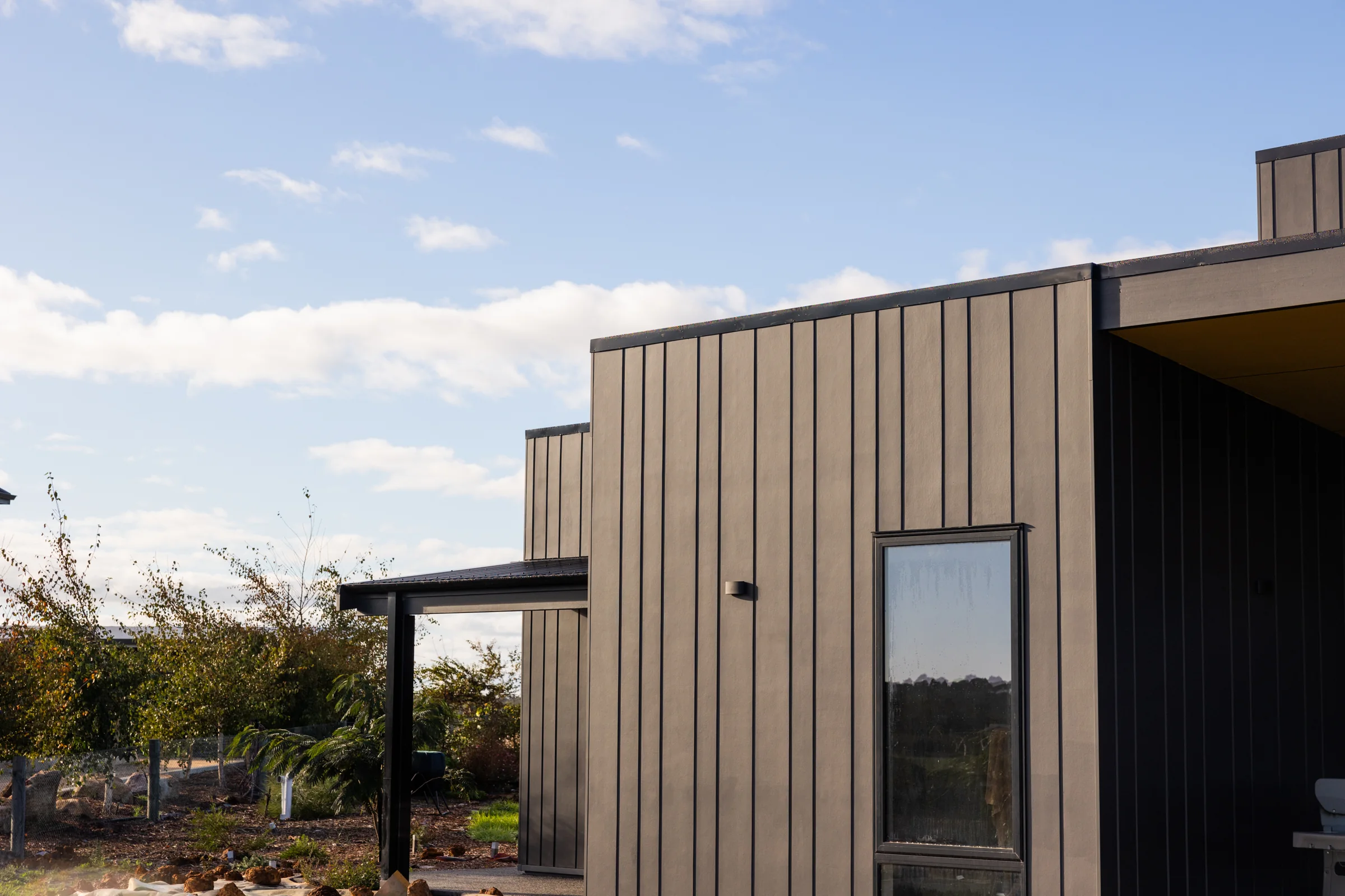 James Hardie Oblique cladding in mixed board widths beside Axon vertical-groove cladding