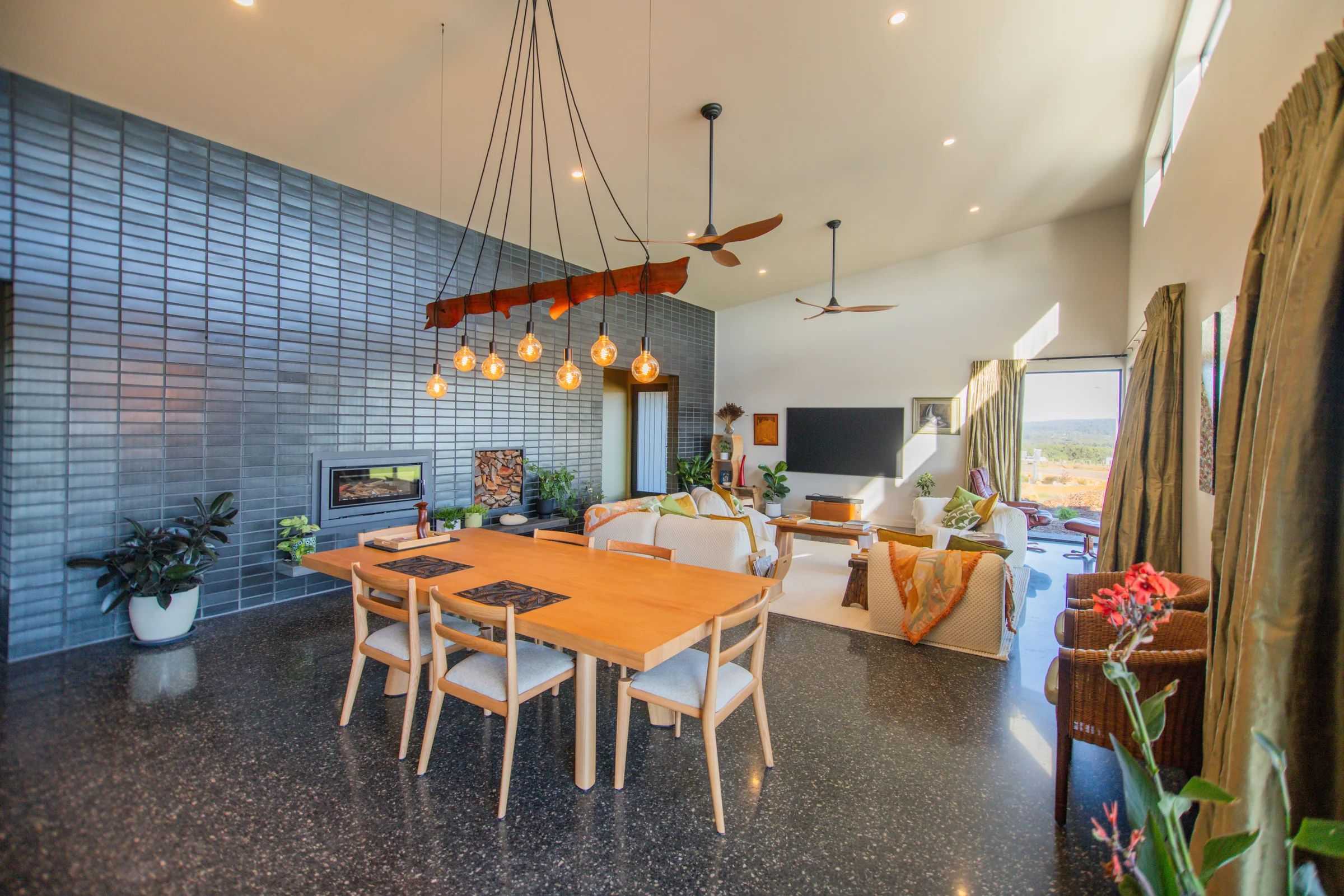 Dining and living area under a raked ceiling, looking toward the hills