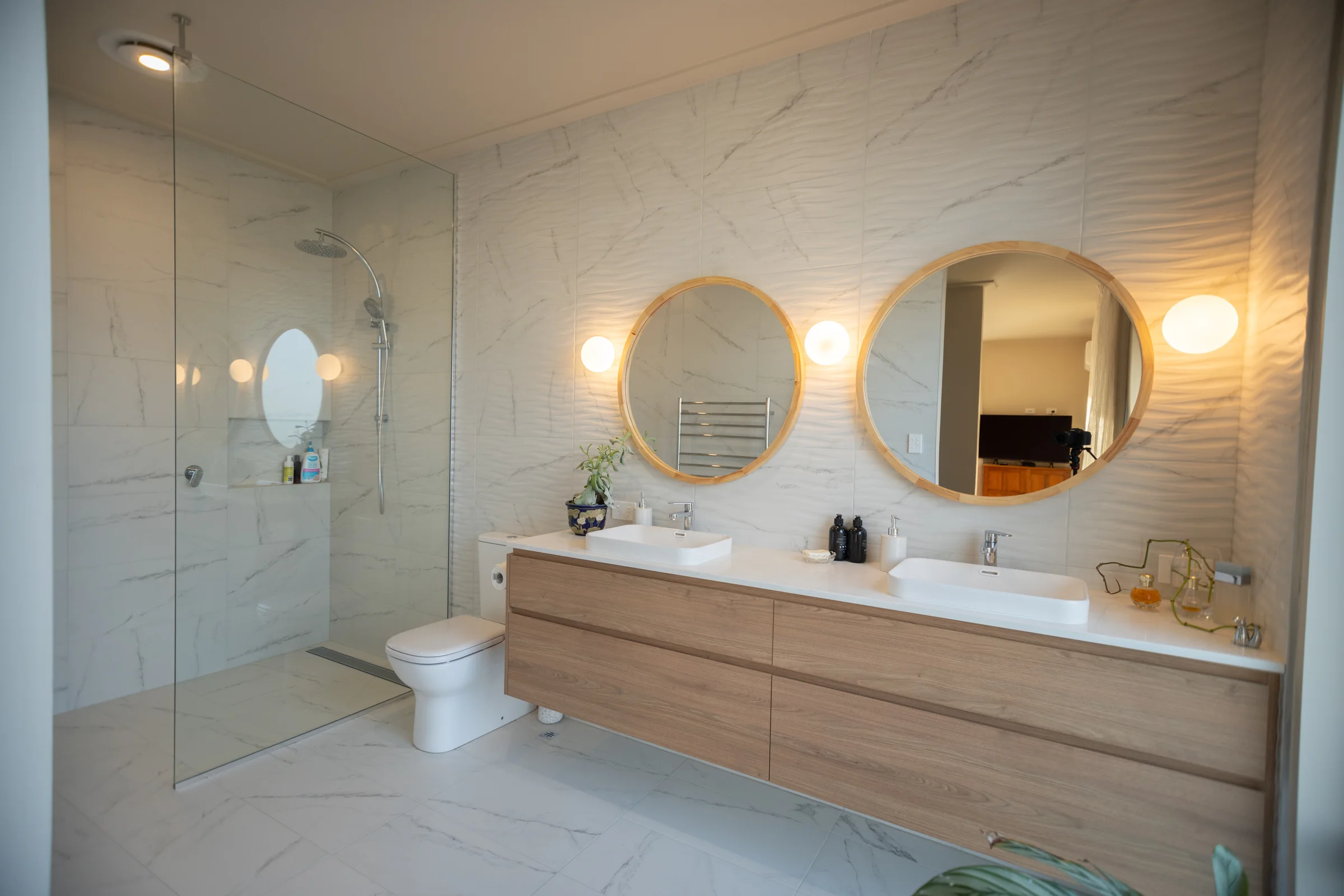 Ensuite with a floating double vanity and walk-in shower