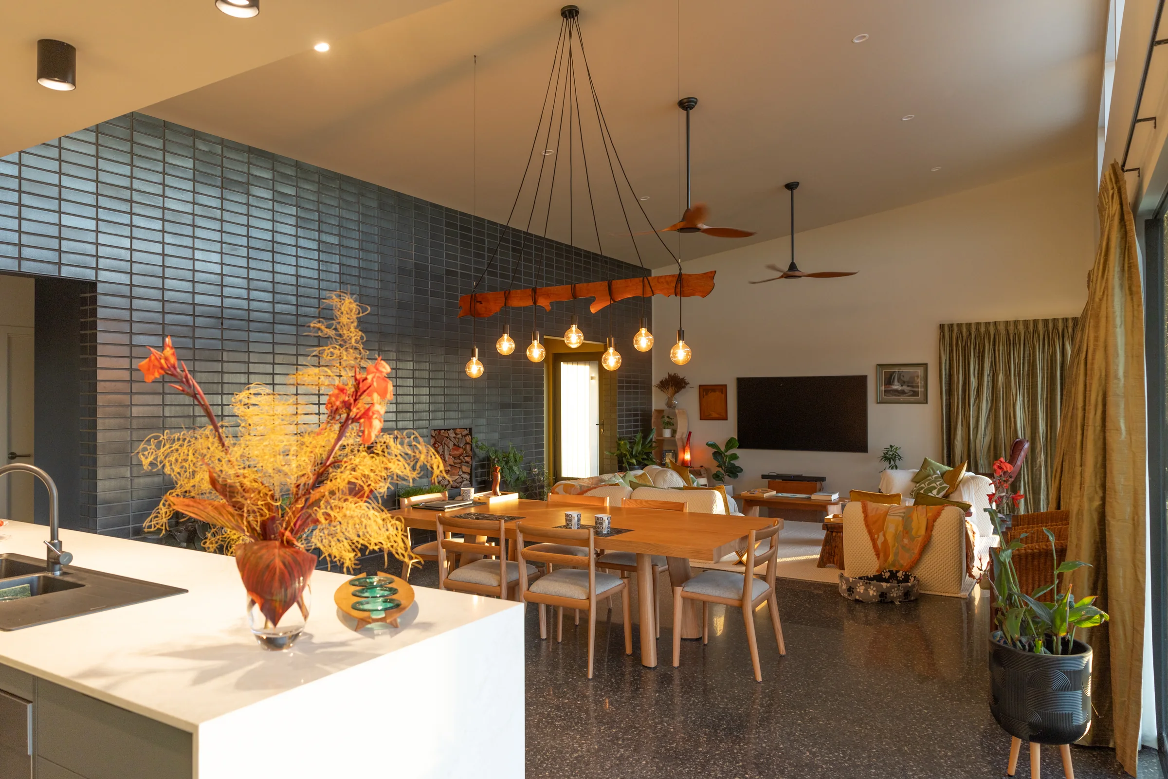 View from the kitchen island across the dining table to the living area