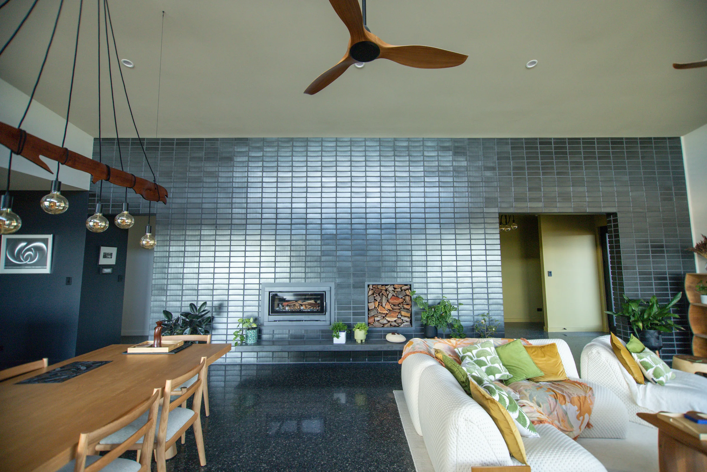 Glazed brick fireplace wall and lounge in afternoon light