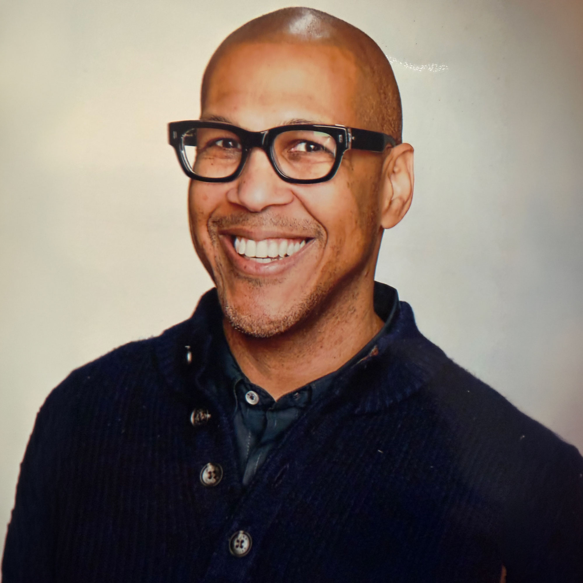 Jeremy Carr, The Lazy Thrifter, smiling in glasses and a dark sweater.