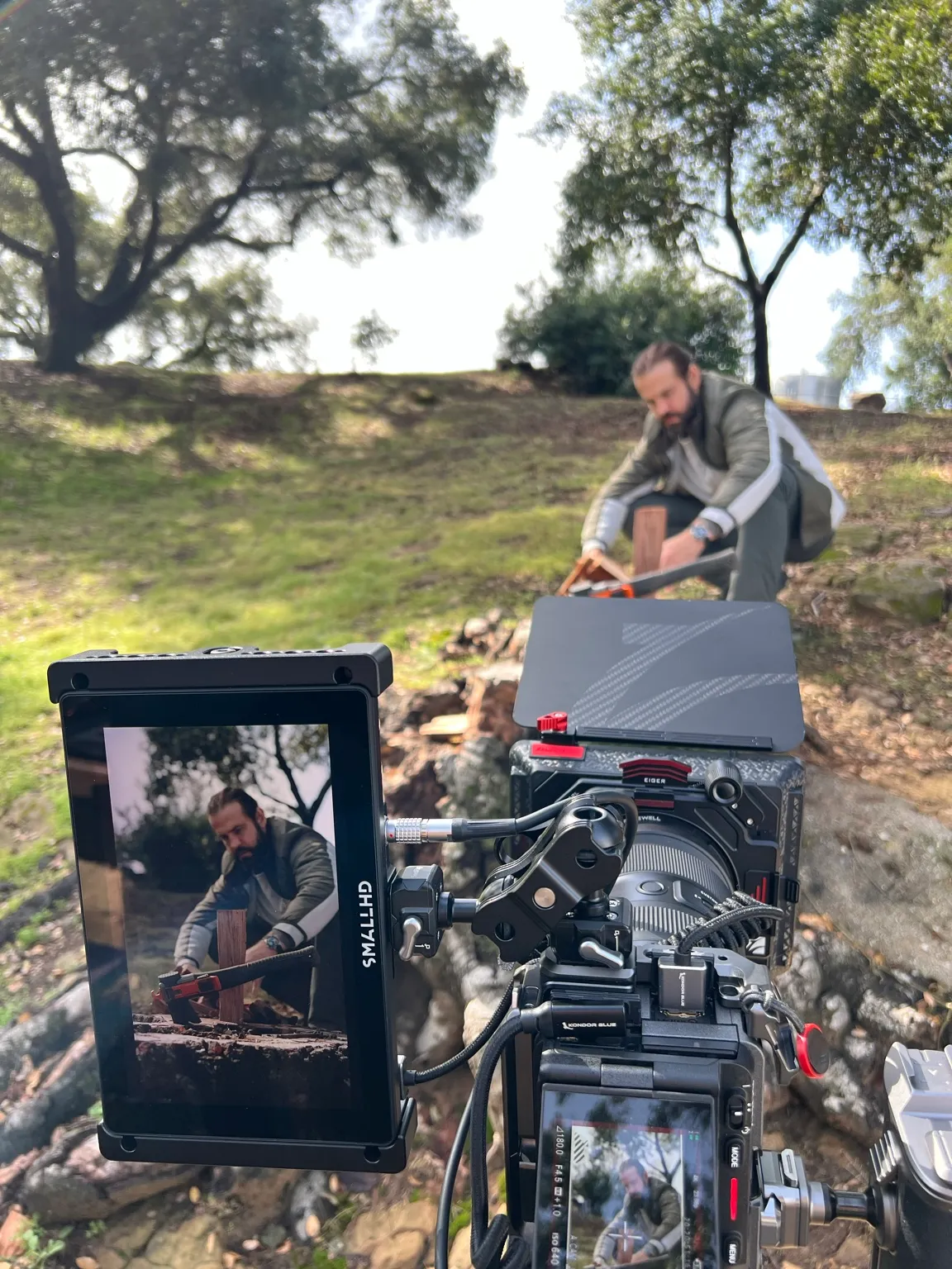 Chris Cole filming a staged rescue scene on a hillside