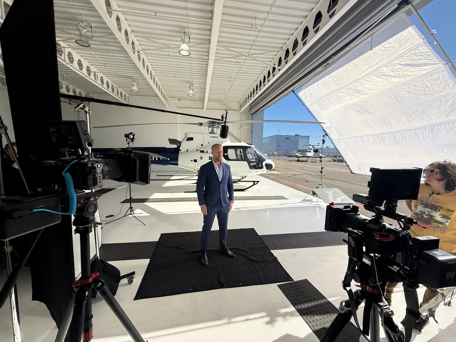 Preparing the slate for an interview beside a helicopter