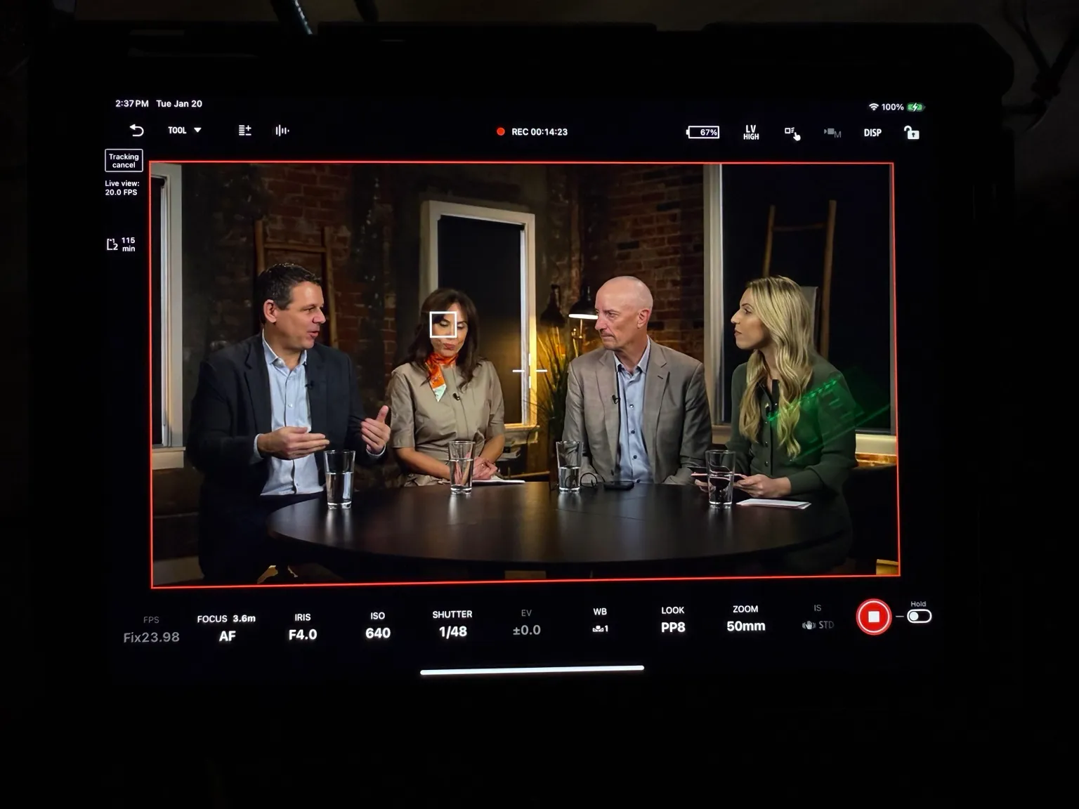 Camera monitor showing a four-person panel discussion