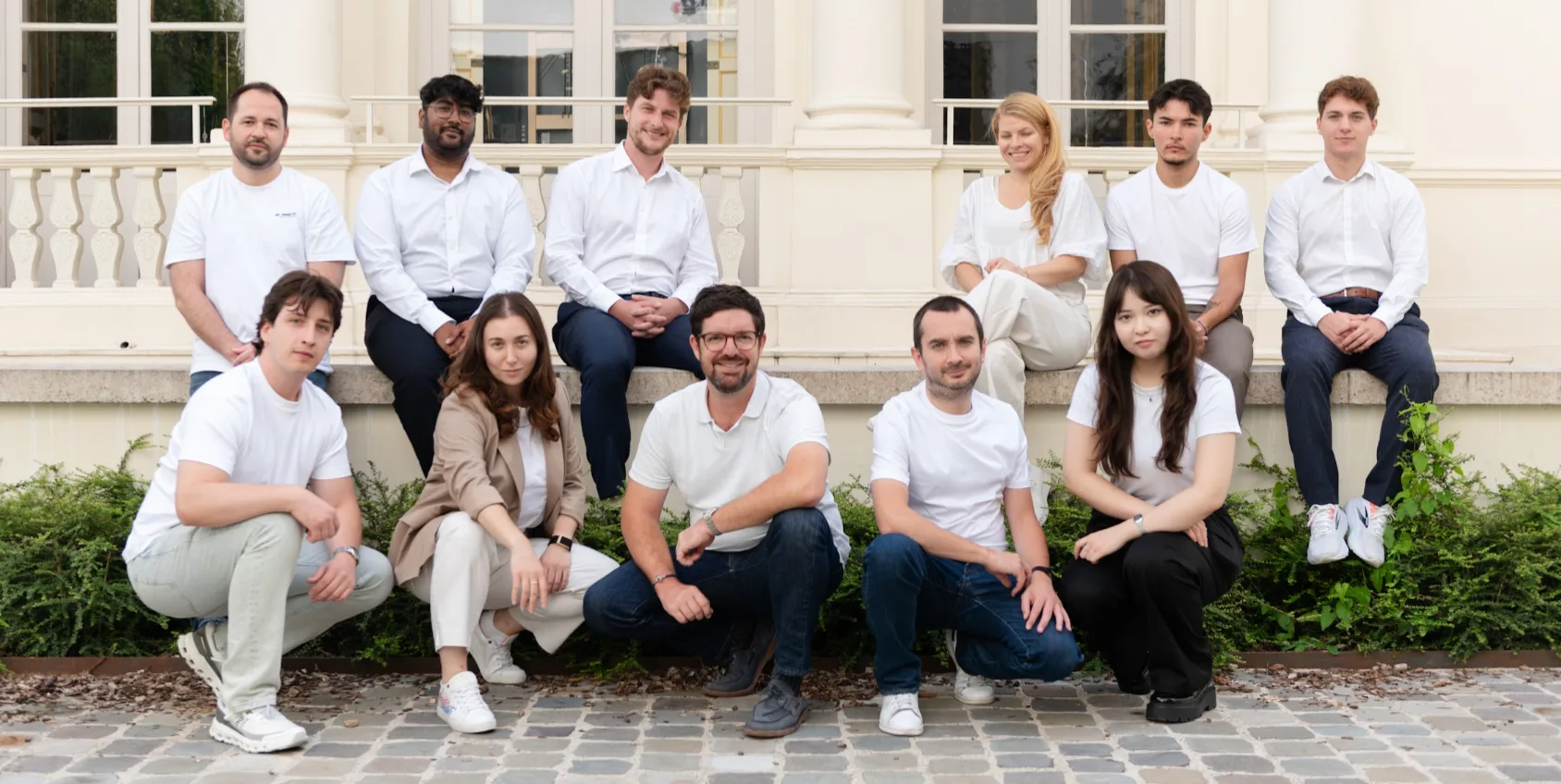 The Initiativ team together in front of a classic Parisian building