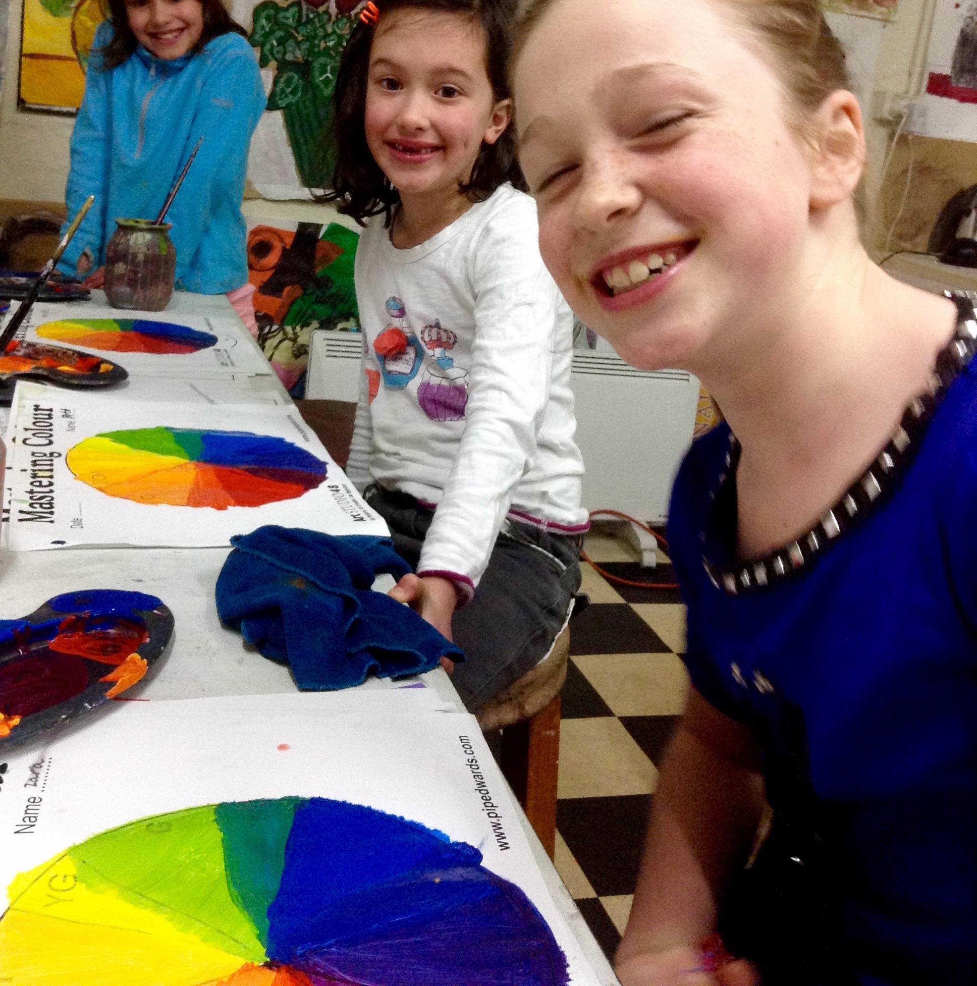 Students smiling with their colour wheel worksheets
