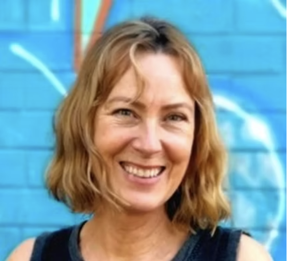 Pipa smiling in front of a mural