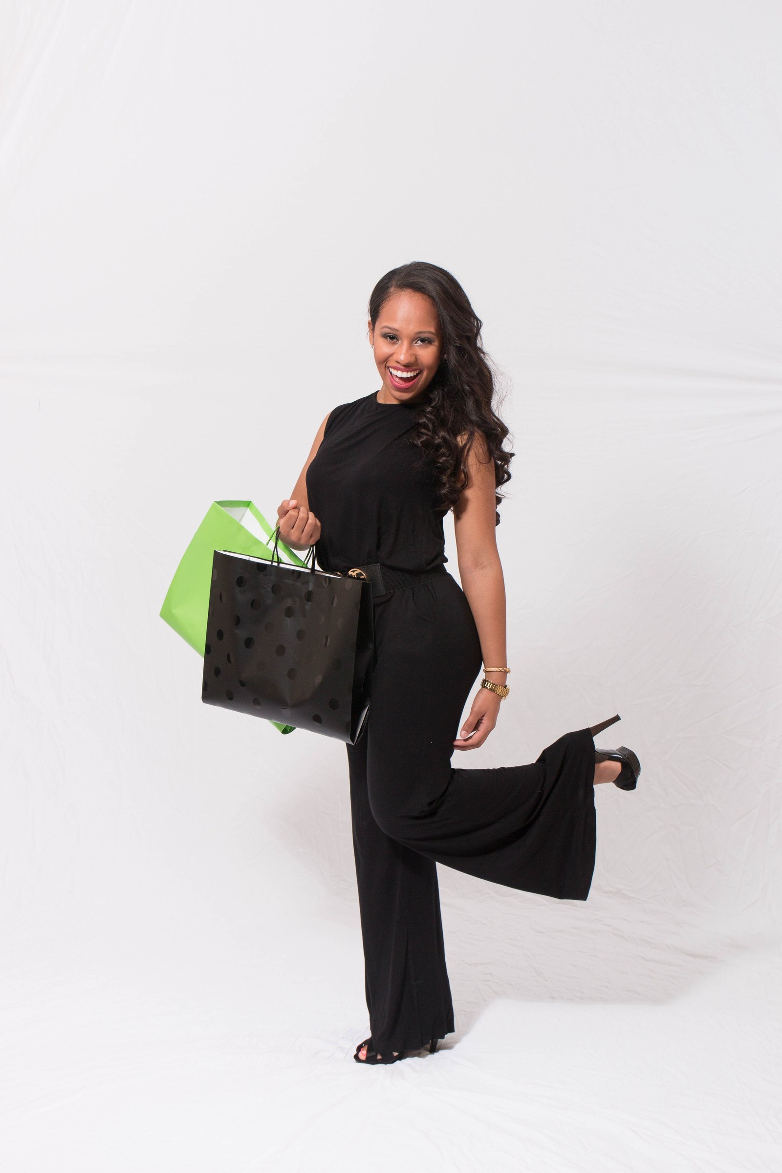 ProntoWash Eco AutoSpa campaign model holding black and green shopping bags.